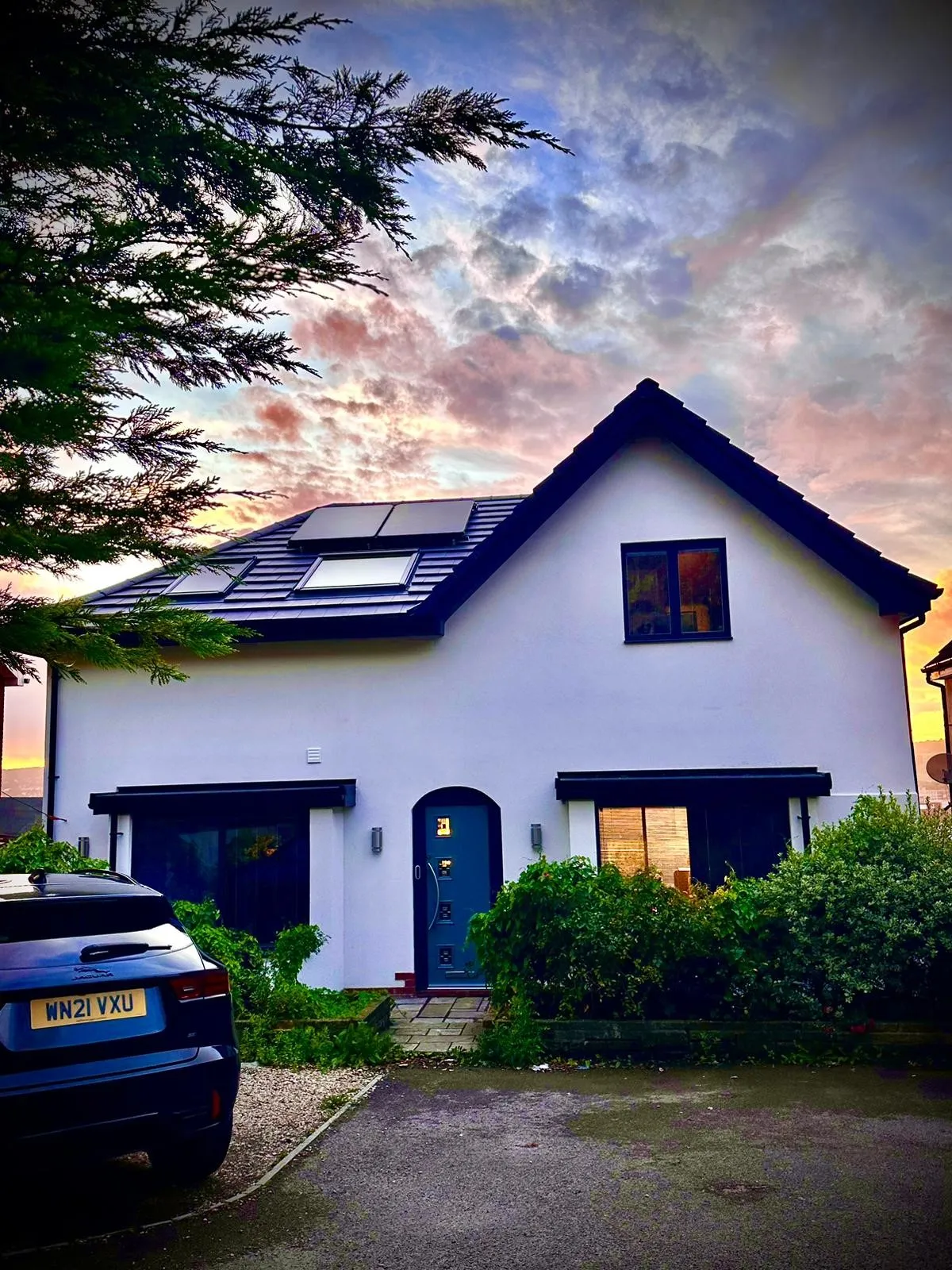 A house with a car parked in front of it.